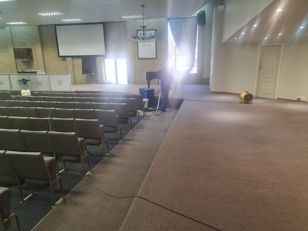Commercial carpet cleaning in a Pretoria church hall with air mover drying